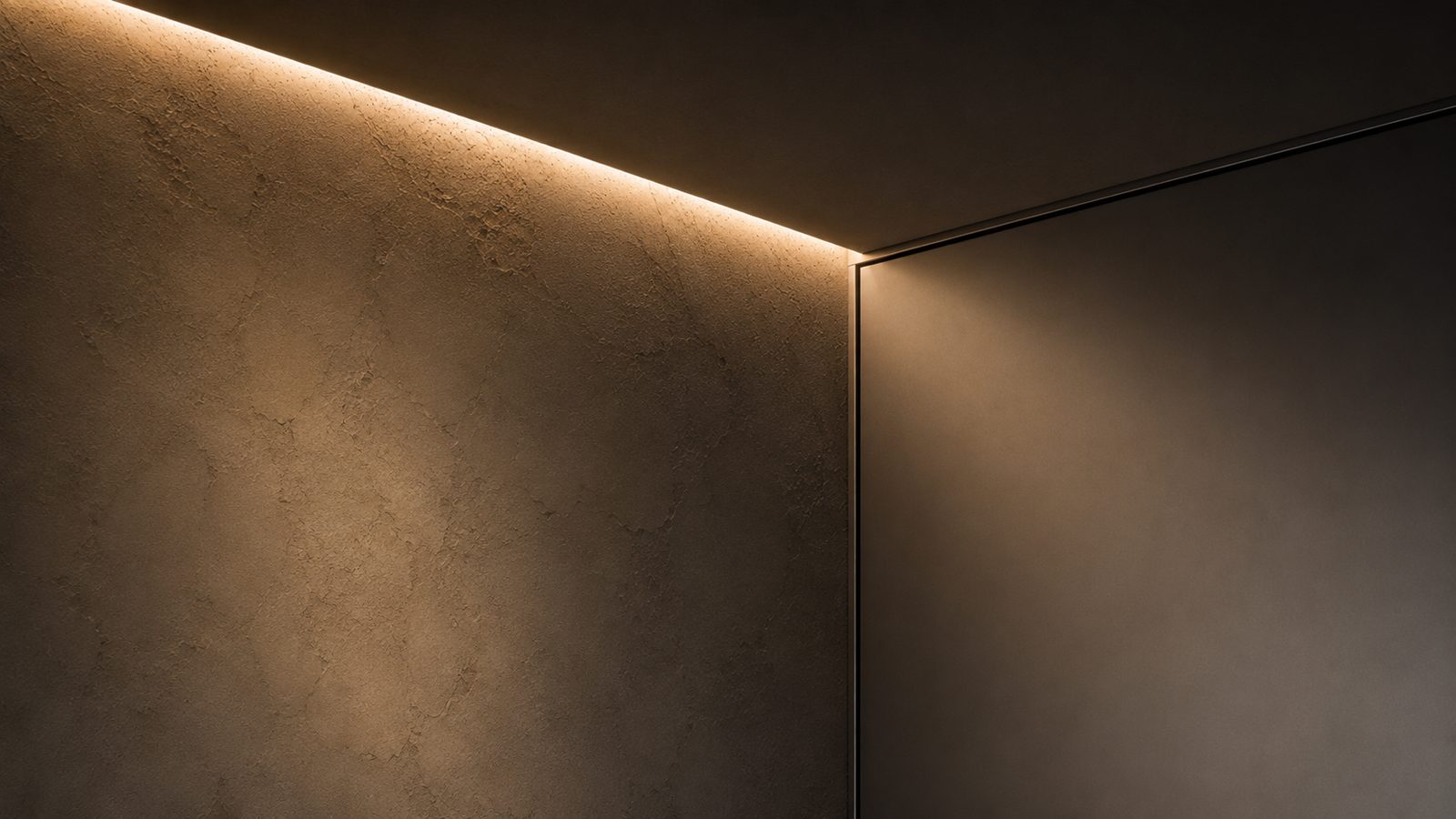 Concealed LED cove light washing a textured plaster wall